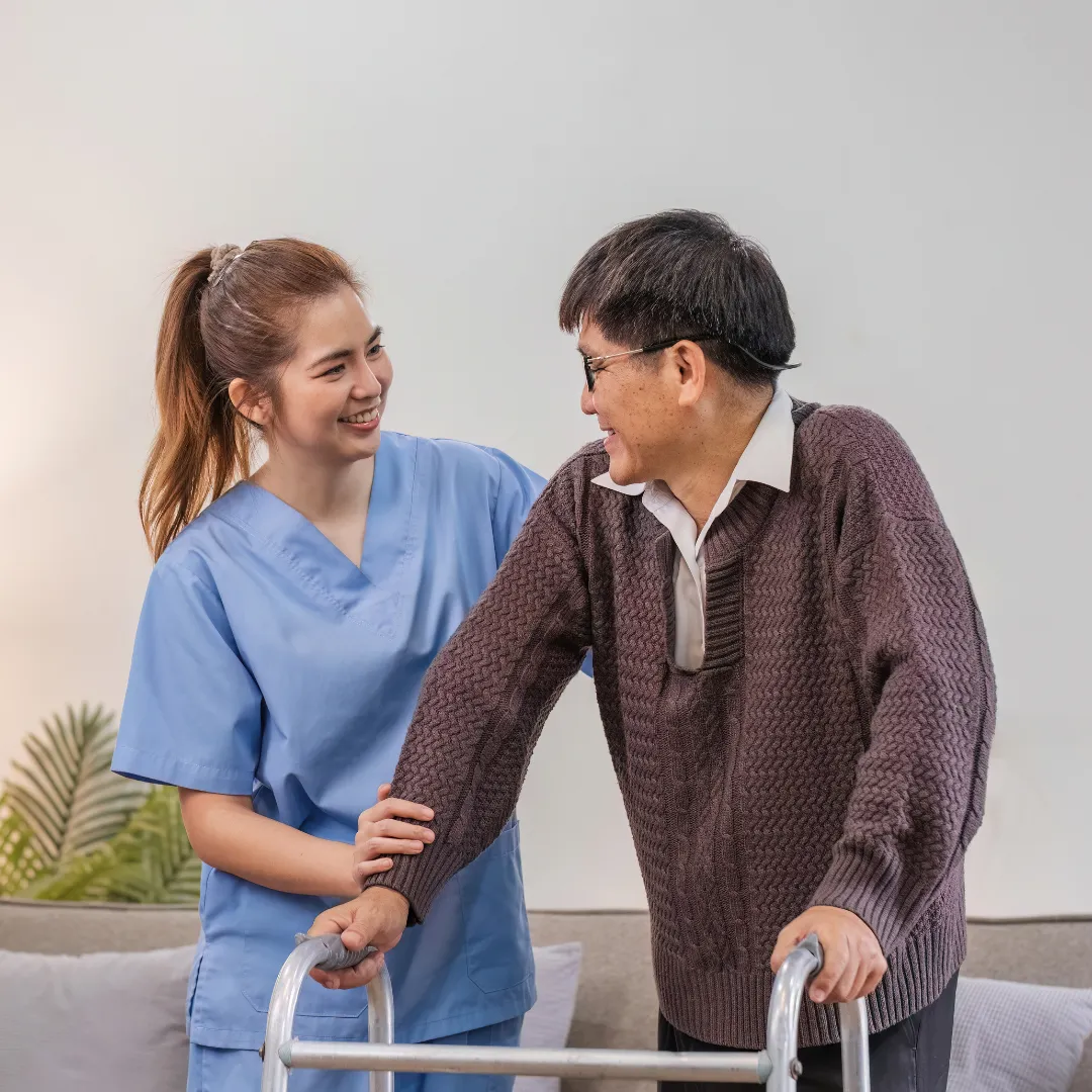 Professional caregiver assisting an older adult with mobility during home care in Columbus, OH.