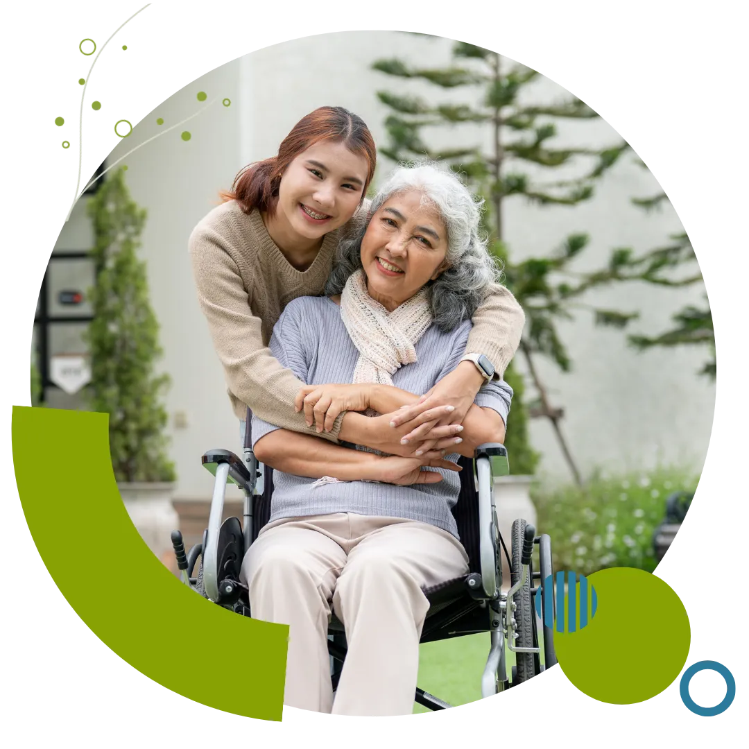 A Caregiver provides supportive home care services to an older woman using a wheelchair in Columbus, OH.