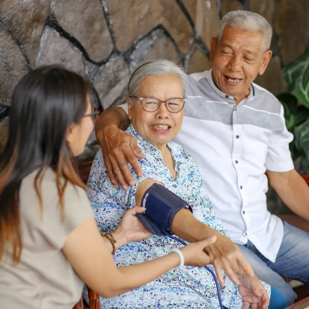 Care professional checking an older adult’s blood pressure during hospital-to-home care in Columbus, OH.
