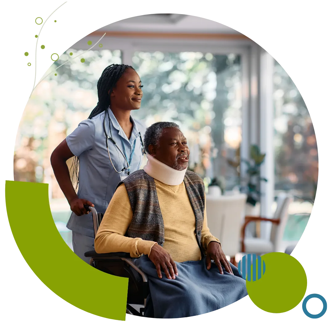 Hospital-to-home care professional assisting an older adult in a wheelchair during recovery after discharge in Columbus, OH.