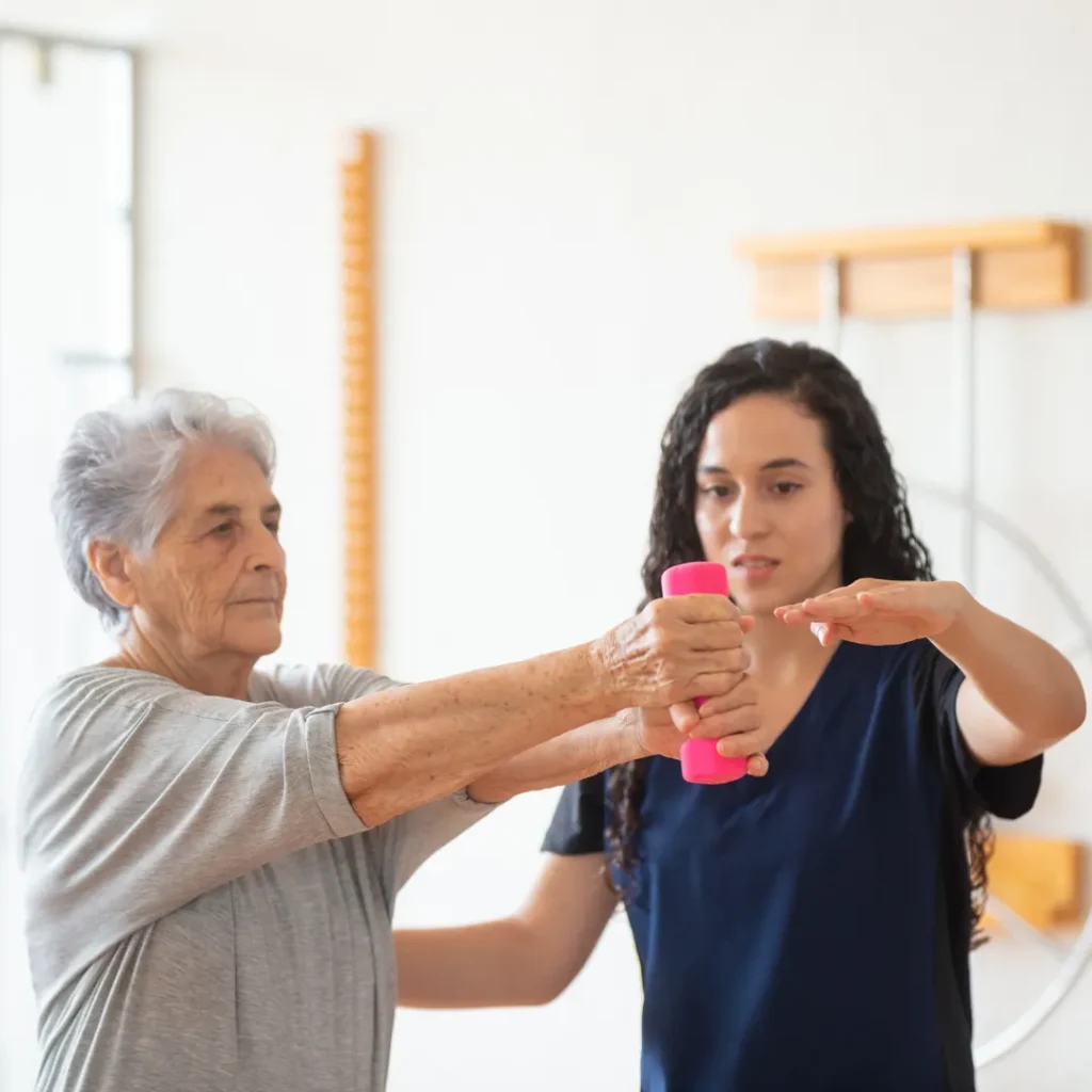 Occupational therapist guiding an older adult through a therapeutic exercise at home in Columbus, OH.