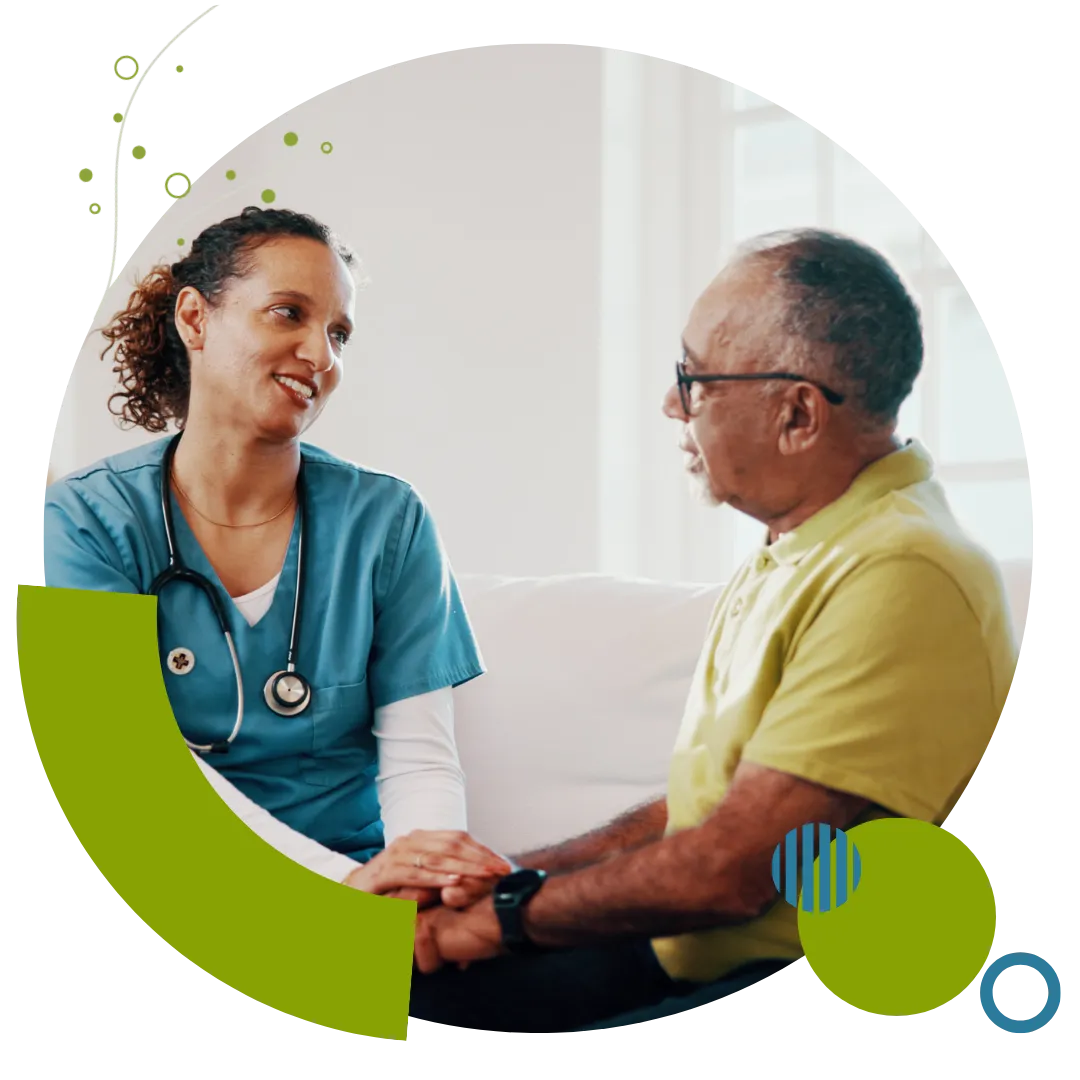 Personal care professional speaking warmly with an older adult while providing supportive in-home care in Columbus, OH.